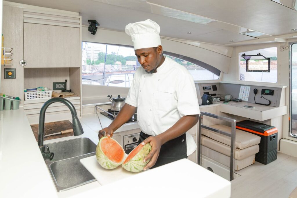 Our chef preparing fresh fruit in the catamaran galley